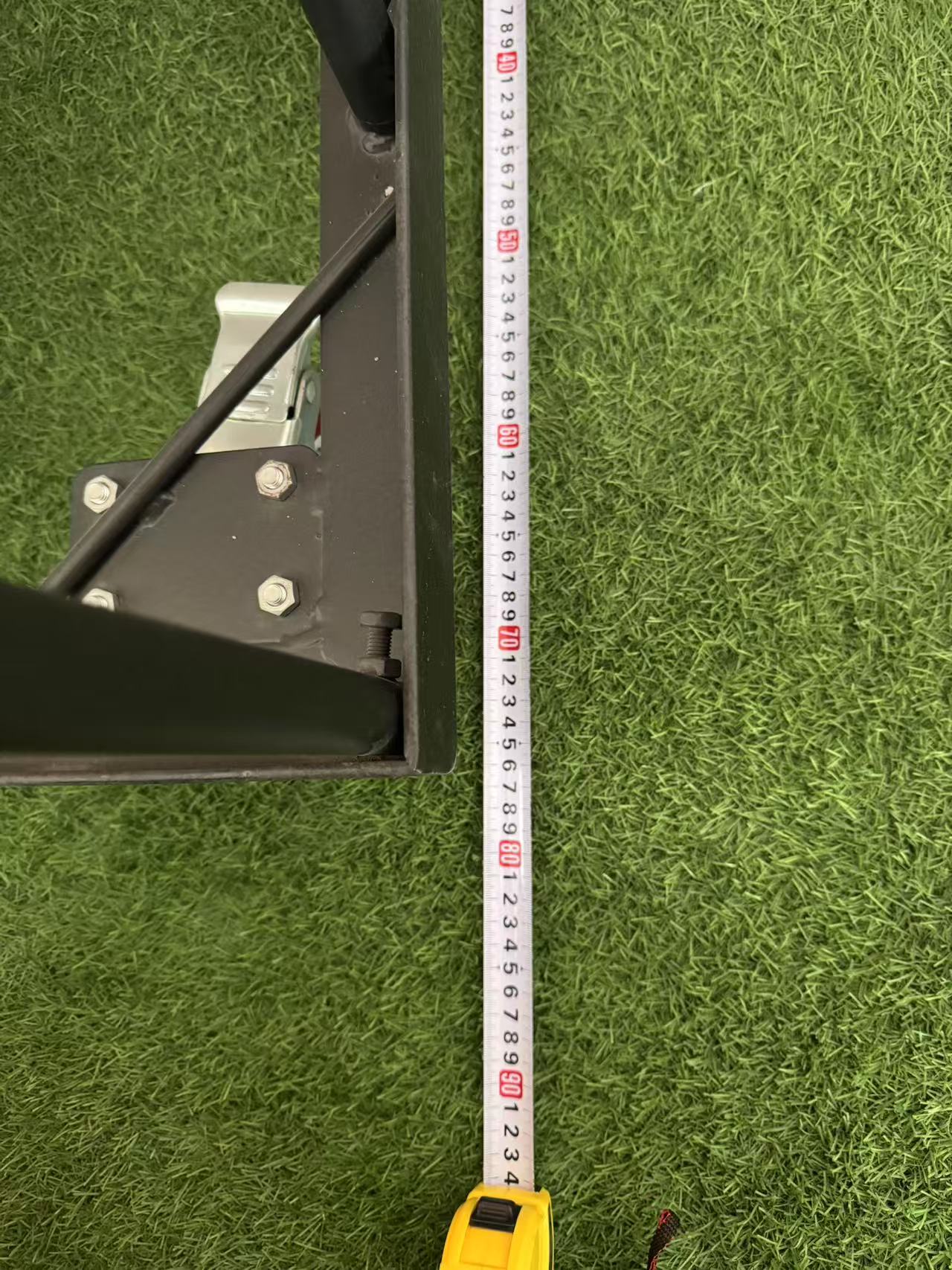 Close view of table trolley frame with measuring tape beside it