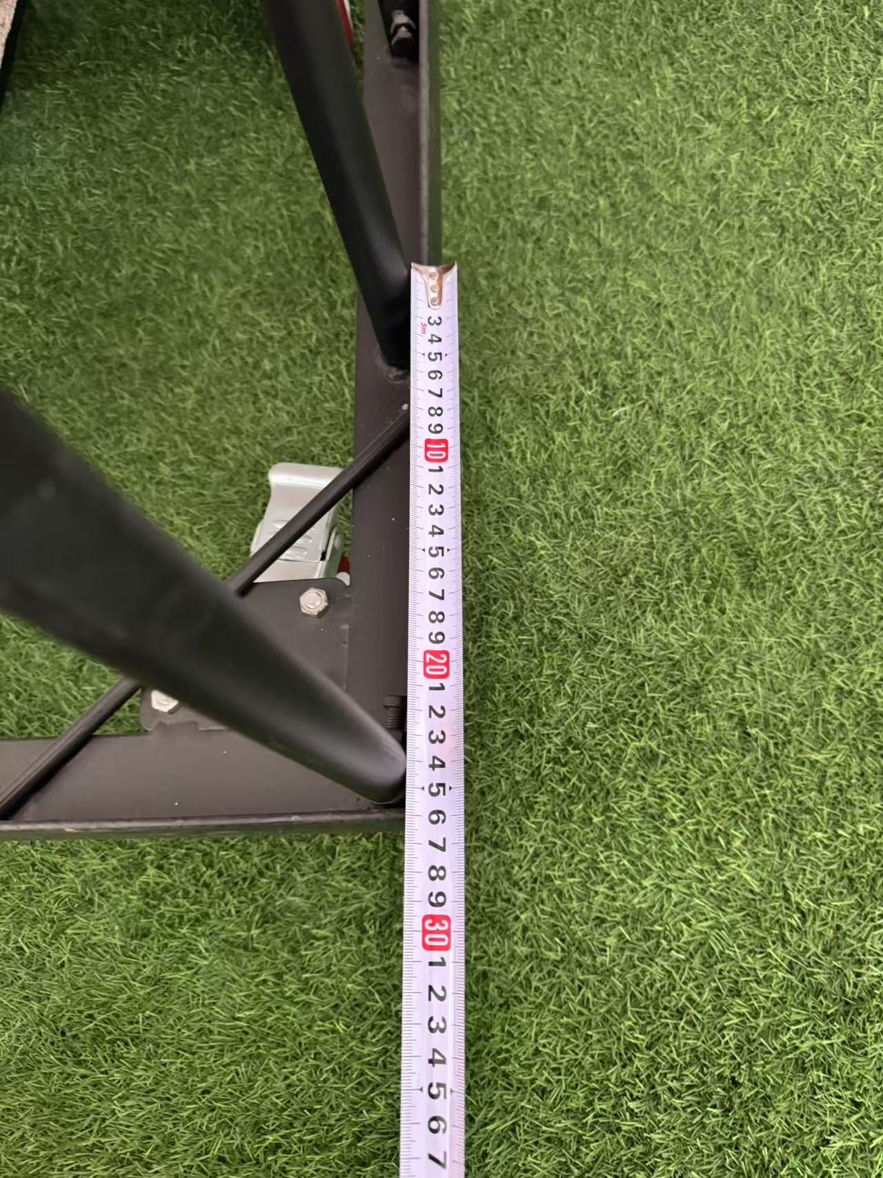 tape measure showing spacing between trolley frame bars