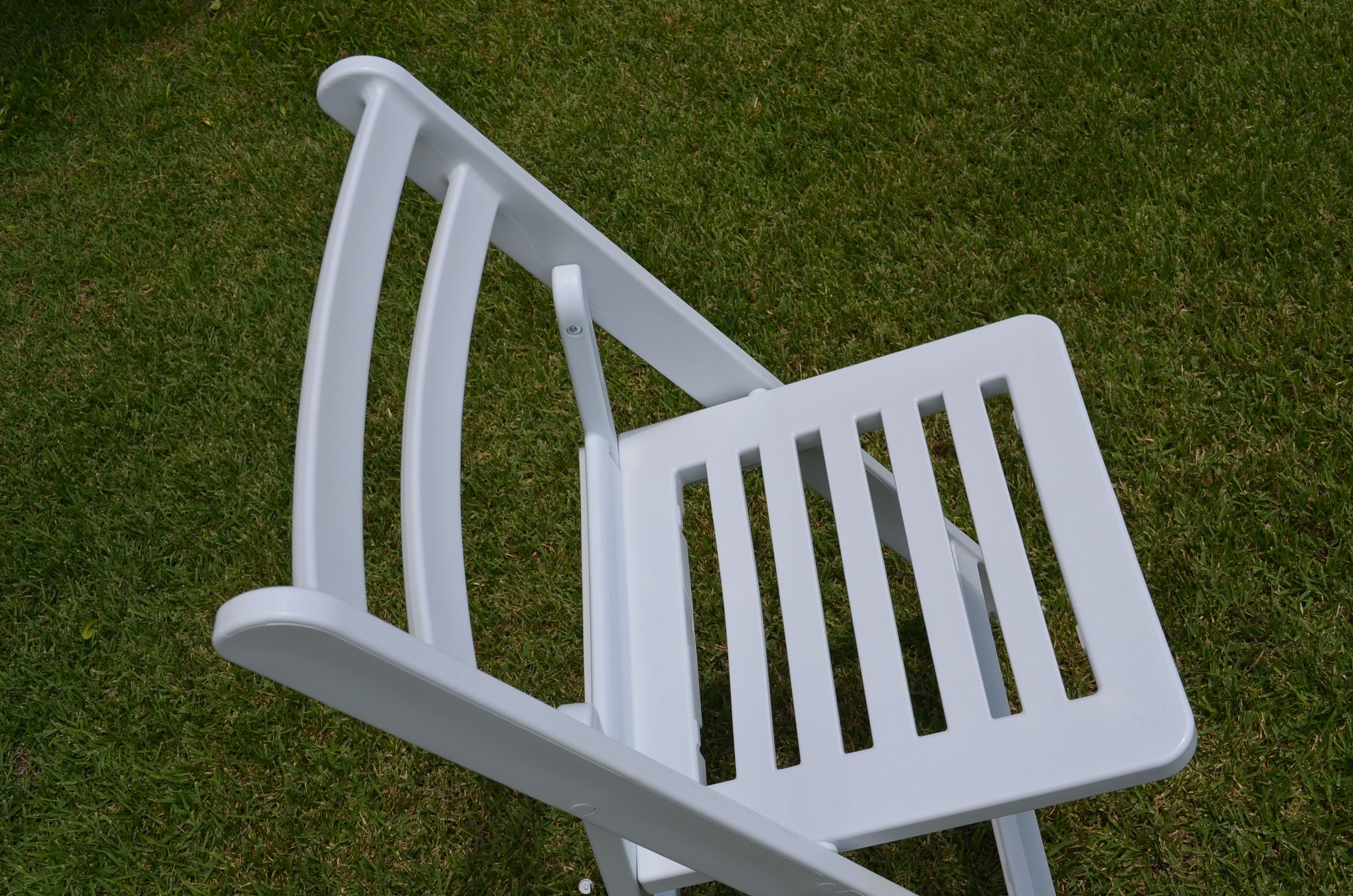 Side view of white Americana folding chair